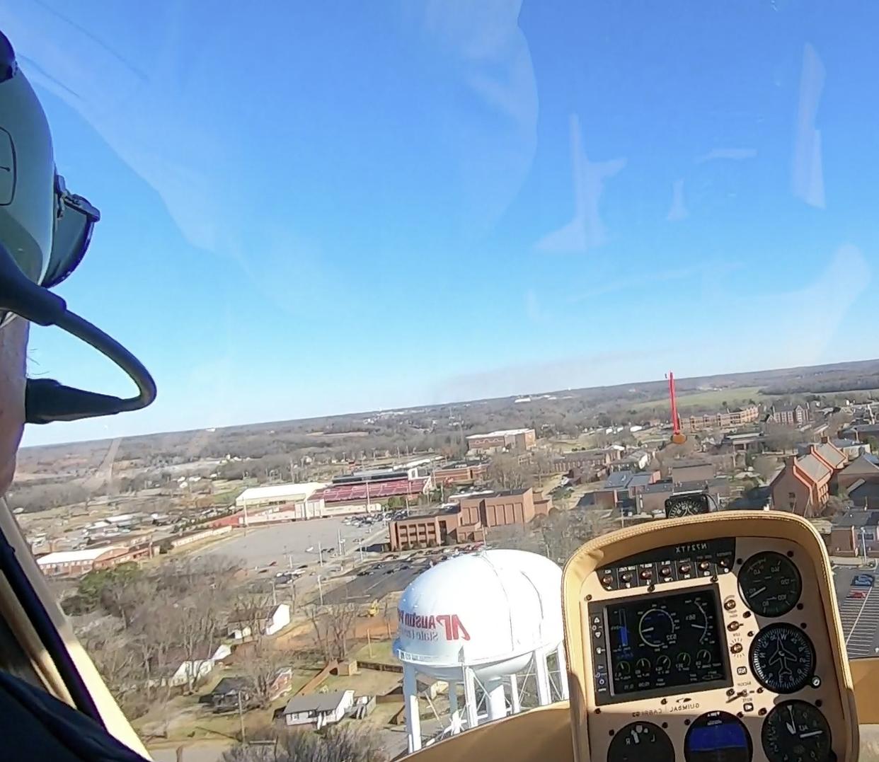 Charlie Weigandt pilots rotor wing helicopter over 365bet water tower