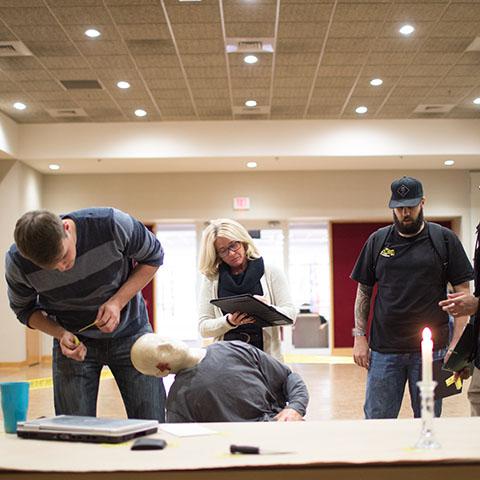 Criminal justice students examine mock crime scene