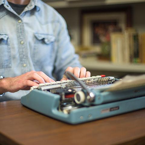 Conor Scruton writes poetry on typewriter in library